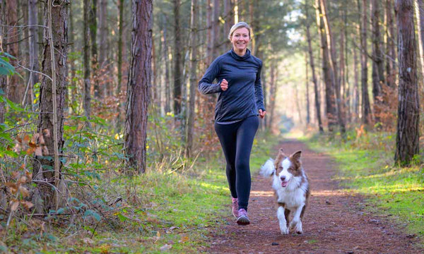 Dog running with owner